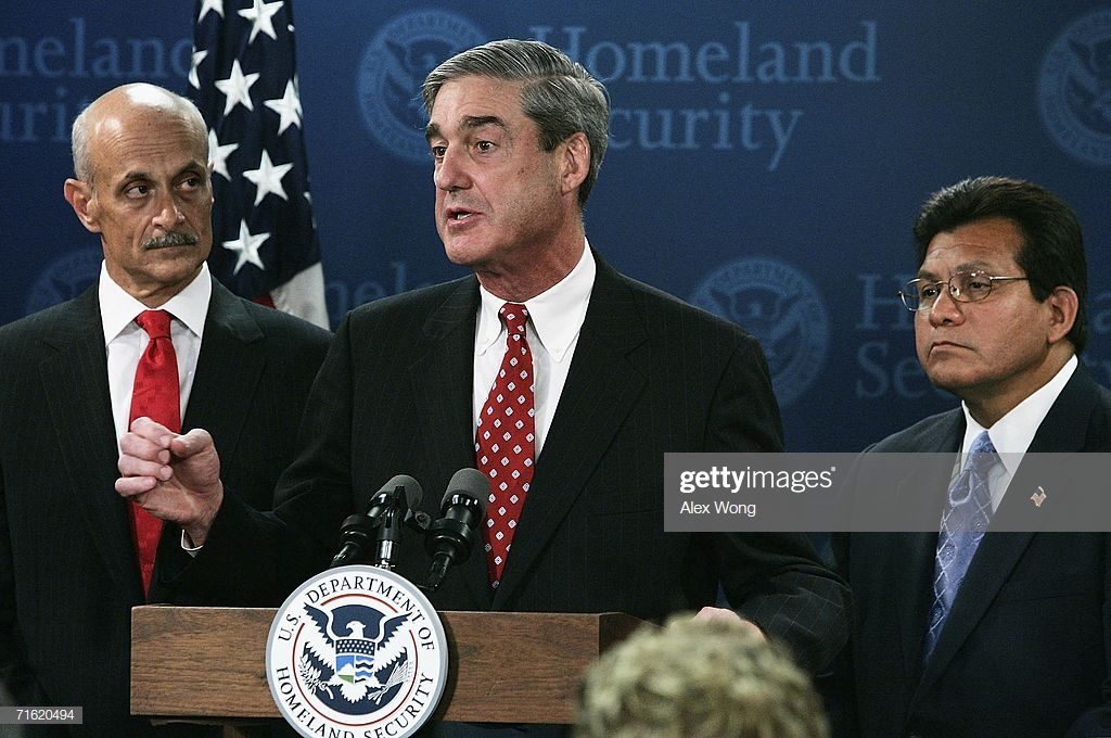 WASHINGTON - AUGUST 10:  FBI Director Robert Mueller (C) speaks as U.S. Homeland Security Secretary Michael Chertoff (L) and Attorney General Alberto Gonzales (R) look on during a news conference at the Homeland Security Department August 10, 2006 in Washington, DC. This is the first time that the red alert level, which designates a 